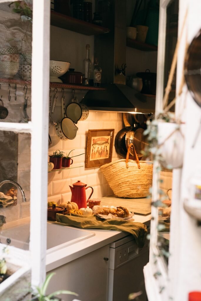 a cozy kitchen with small decorate pumpkins, a basket and a warm light