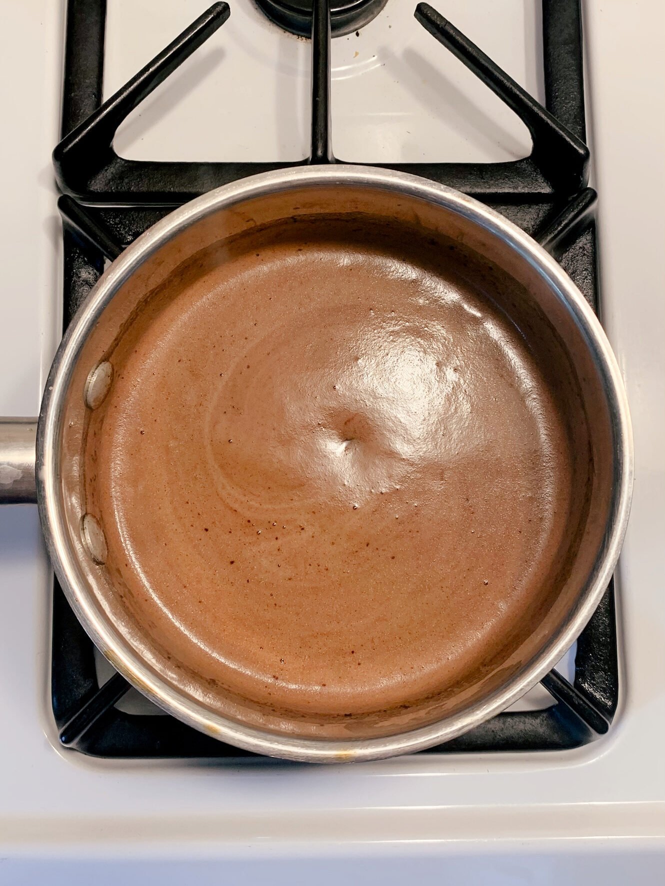 Ingredients fresh milled Texas sheet cake boiling on the stove in a saucepan