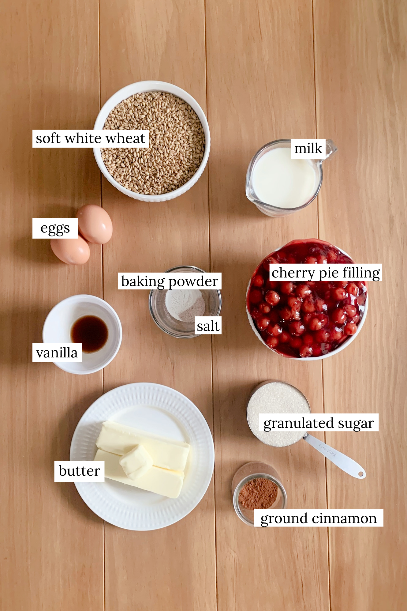 Ingredients for fresh milled cherry coffee cake in small dishes on a wooden surface
