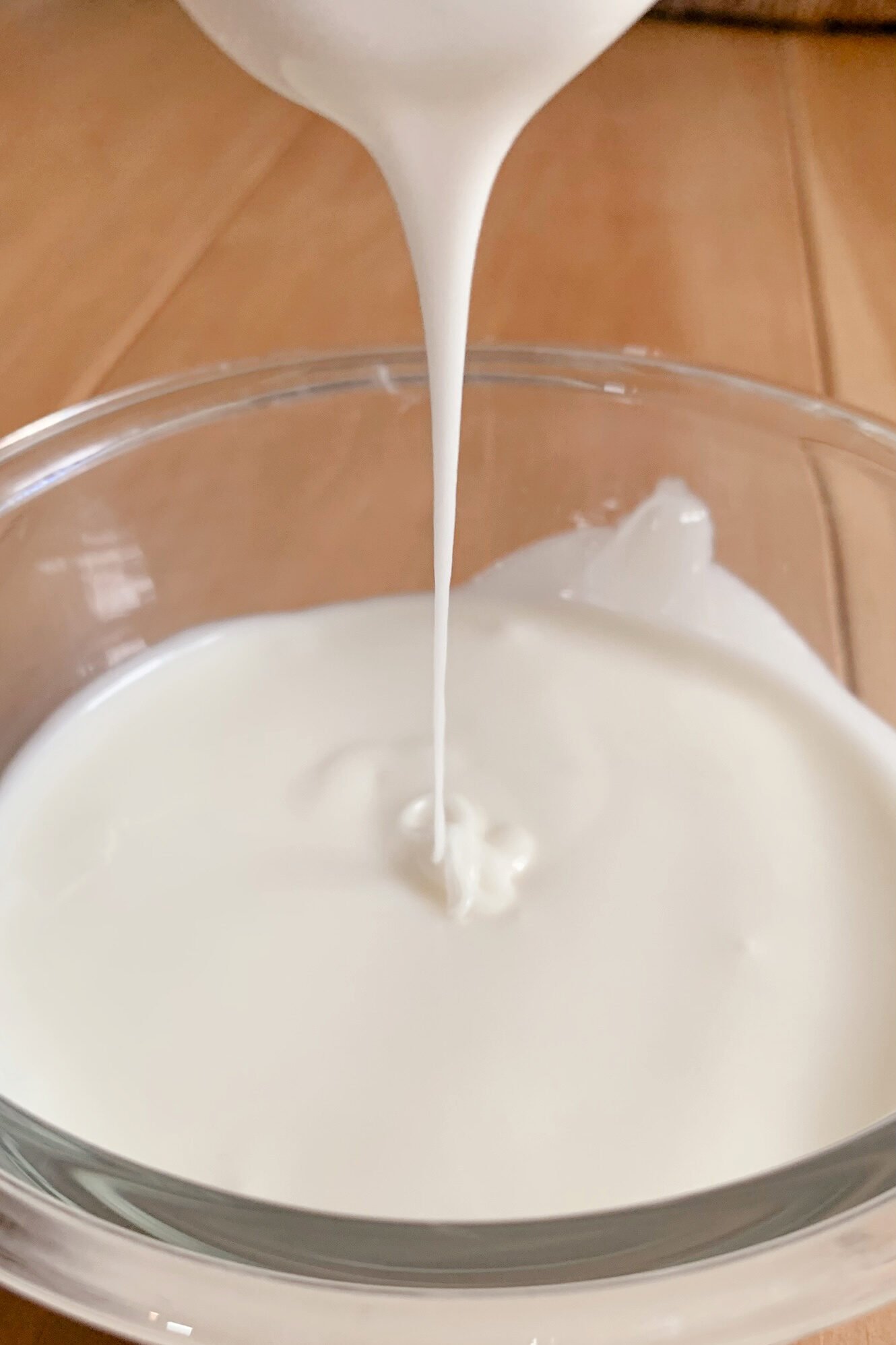powdered sugar glaze drizzled in a small glass bowl