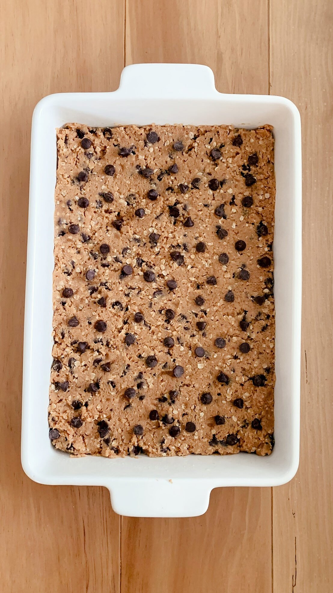 The unbaked fresh milled peanut butter oatmeal chocolate chip cookie bars in a dish